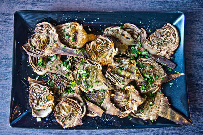 Artichokes baked with oil, parsley and lemon — Stock Photo