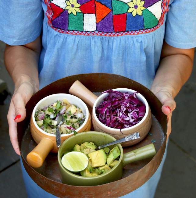 Woman serving selection of mexican salsa — Stock Photo