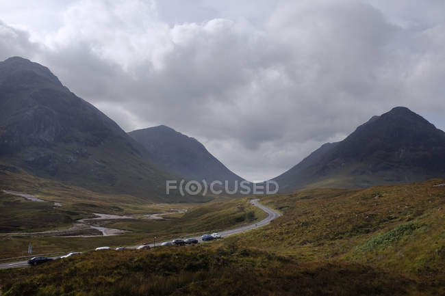 Scenic view of row of cars parked on road, Highlands, Scotland, UK — Stock Photo
