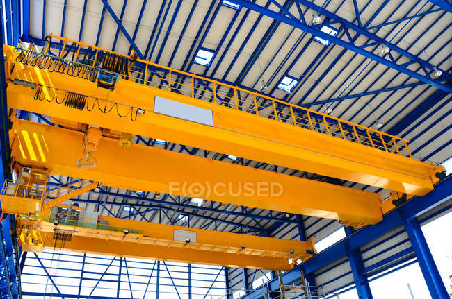Low angle view of crane in factory — Stock Photo