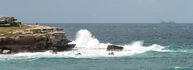Vista panorámica de las olas estrellándose contra las rocas, Bondi Beach, Nueva Gales del Sur, Australia - foto de stock