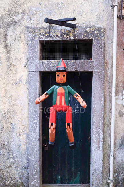 Traditional wooden puppet hanging outdoors — Stock Photo