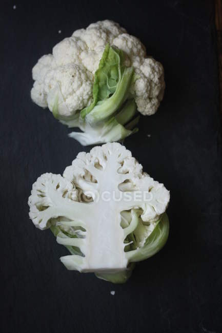 Fresh ripe cauliflower over black background — Stock Photo