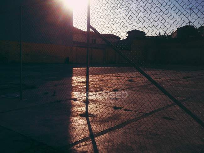 Scenic view of chainlink fence at sunset — Stock Photo