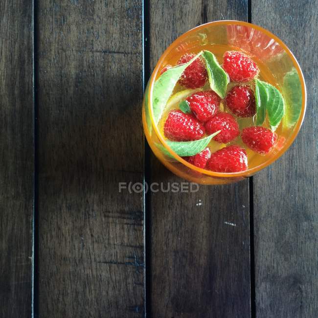 Raspberry Basil Limoncello in glass on wooden surface — Stock Photo