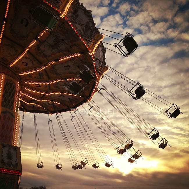 Empty vintage carousel swinging during sunset time — Stock Photo