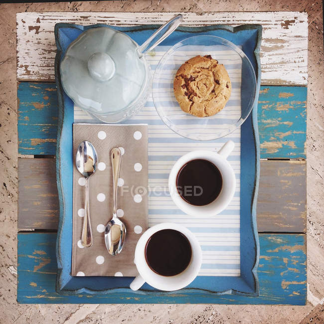 Top view of tray with coffee, sugar and cookies on wooden table — Stock Photo