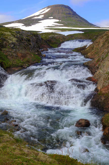 Iceland, Westfjords, scenic view of small stream in front of mountain — Stock Photo