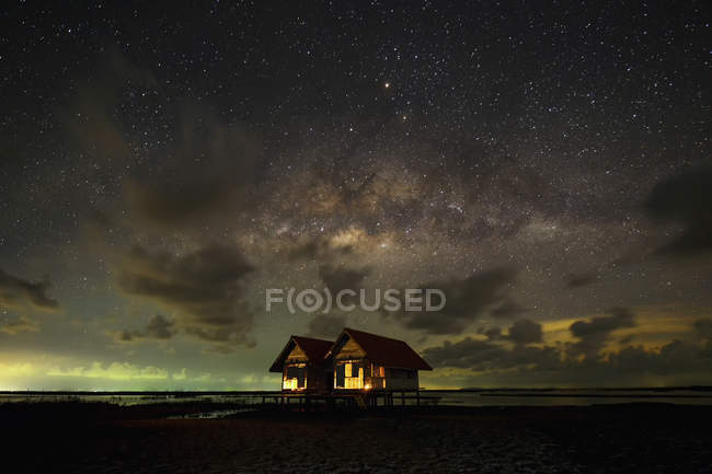 Majestic Milky Way over wooden huts, Thailand — Stock Photo