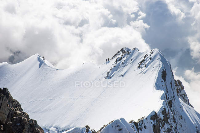 Four People walking along Mountain Ridge in the Swiss Alps, Piz Bernina, Graubunden, Switzerland — Stock Photo