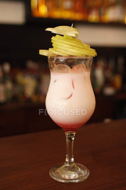 Tasty fruits cocktail at bar counter, blurred background — Stock Photo