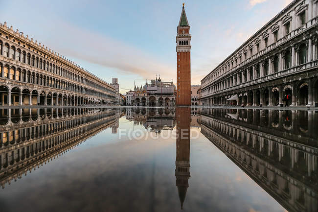 Italy, Venice, Piazza San Marco, Symmetrical view of architecture reflecting in water — Stock Photo