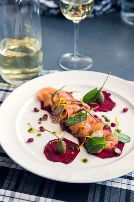 Smoked salmon and beetroot with caperberries — Stock Photo