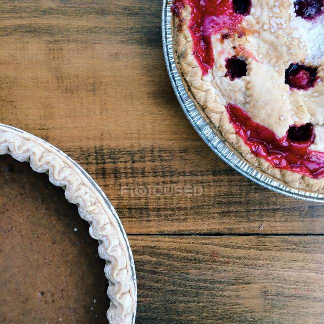 Close-up of Cherry and pumpkin pies on wooden surface — Stock Photo