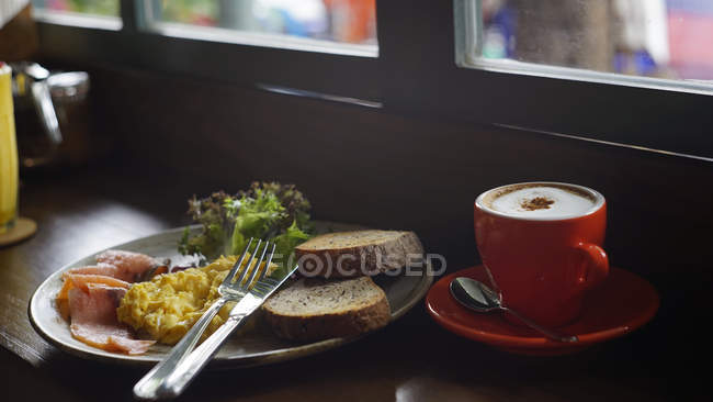 Breakfast meal with a cup of cappuccino in the soft light mood with a little blurry — Stock Photo