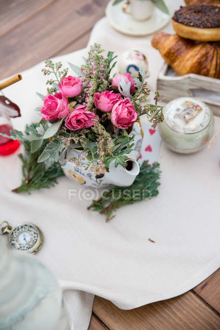 Composition of flowers and afternoon tea on table — Stock Photo
