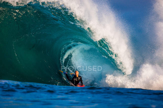 Confident Man bodyboarding barrel wave — Stock Photo