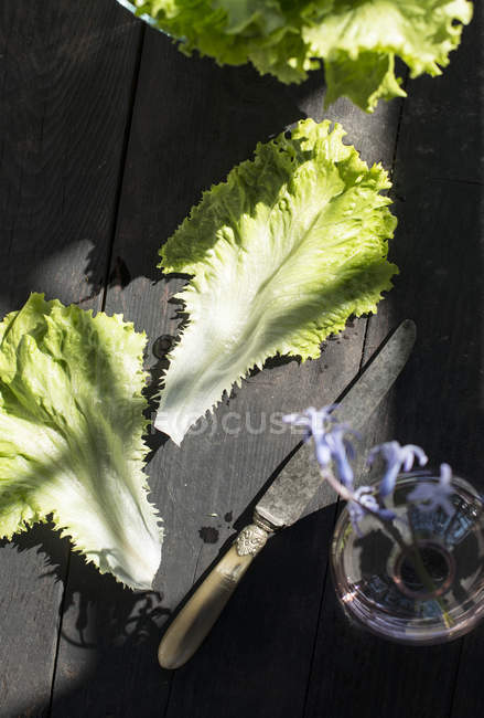 Lettuce leaves on rustic wooden table, closeup — Stock Photo