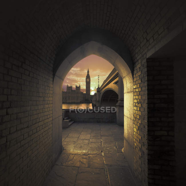 View of Big Ben through an arch across the River Thames, London, UK — Stock Photo