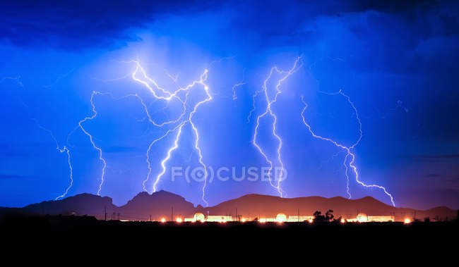 Lighting strike over Palo Verde Nuclear Generating Station behind Saddleback Mountain, Arizona, USA — Stock Photo