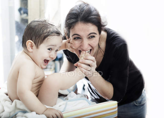 Adorable little boy playing with happy mother — Stock Photo