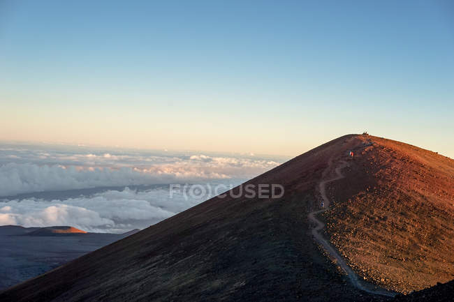 Scenic view from volcano at cloudy mountains — Stock Photo