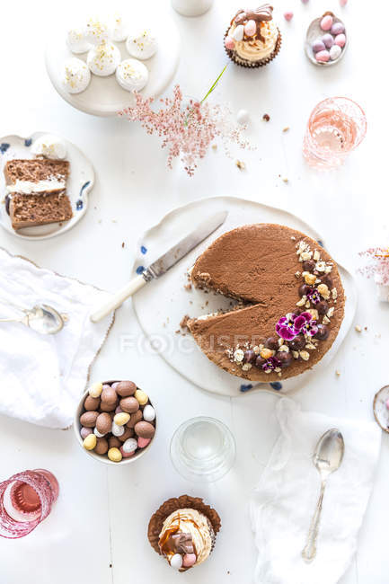 Afternoon tea with chocolate sponge cake and easter eggs — Stock Photo