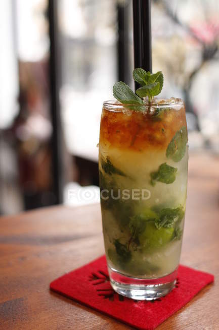 Tasty fresh mojito with two straws, blurred background — Stock Photo