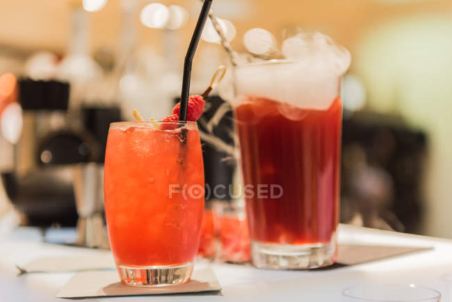 Fruit juice cocktails against blurred background — Stock Photo