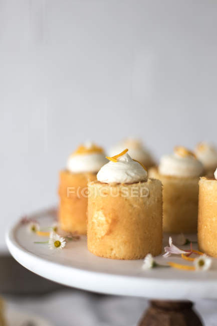 Orange mini sponge cakes on a cake stand — Stock Photo