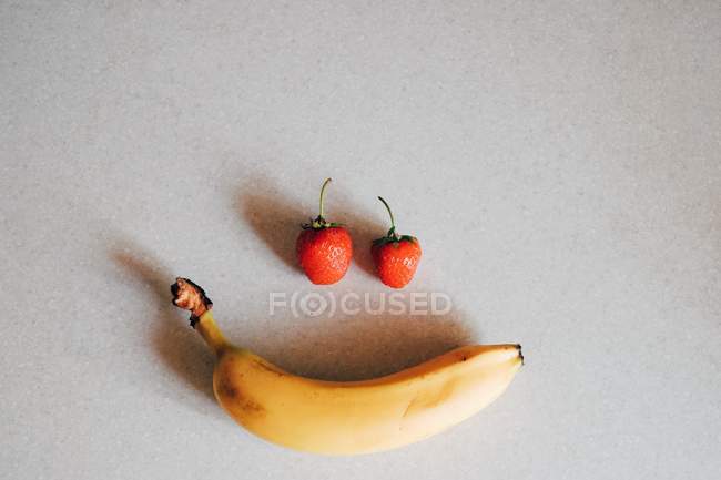 Conceptual fruity face smiling, white background — Stock Photo
