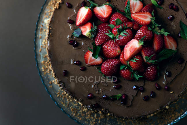 Delicious chocolate cake with fresh strawberries on the top — Stock Photo