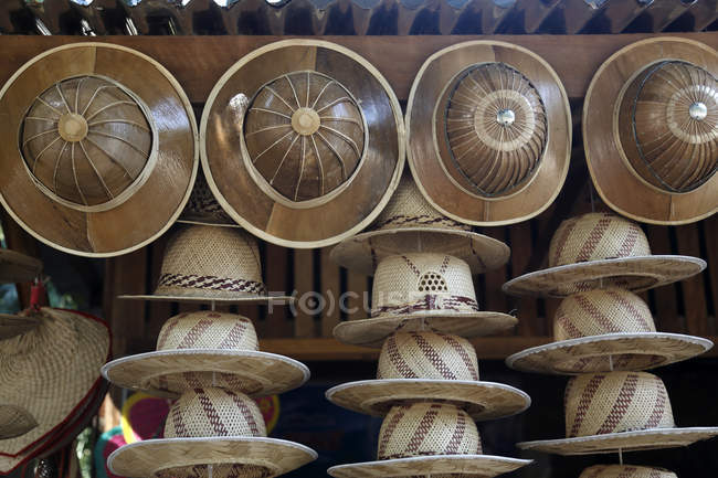 Straw hats for sale at a roadside stall — Stock Photo