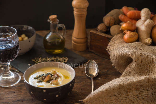 Картофельный суп со сливками и бокалом красного вина — стоковое фото