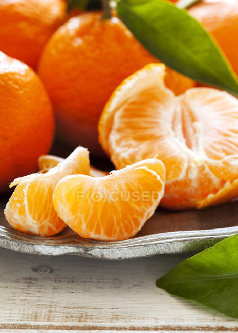 Closeup image of Tangerines lying on plate — Stock Photo