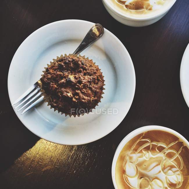 Ansicht von Honig Vanille Latte in weißen Tassen und Muffin — Stockfoto