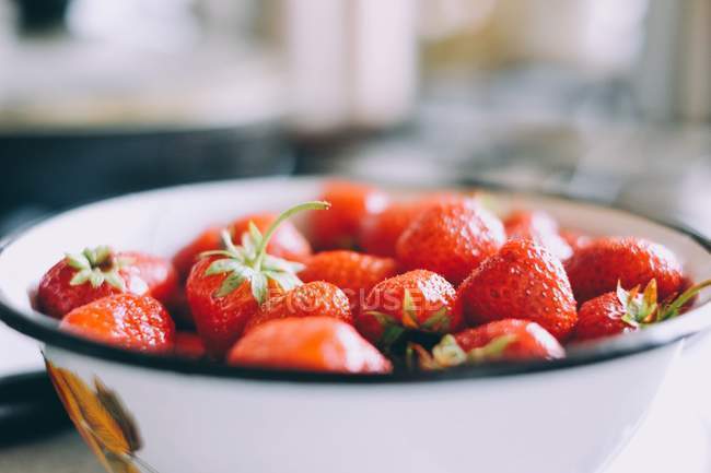 Ein Stapel Erdbeeren in weißem Teller auf dem Tisch — Stockfoto