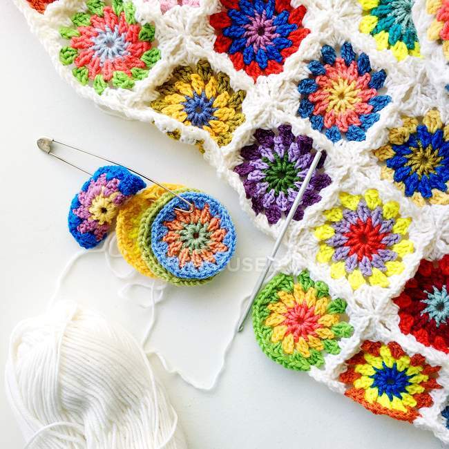 Close-up of crochet blanket over white background — Stock Photo