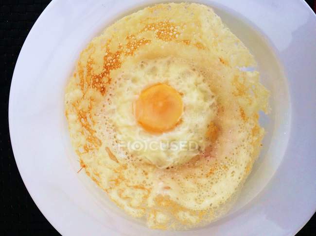 Top view of egg hopper breakfast on white plate — Stock Photo