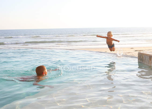 Two caucasian boys having fun in ocean water — Stock Photo