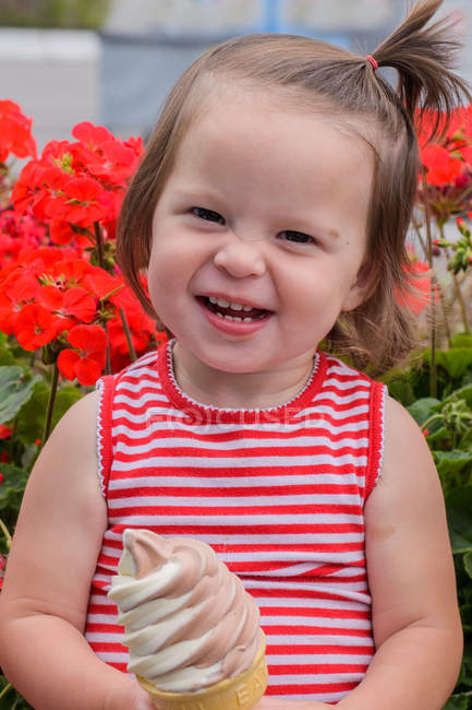 Portrait of a smiling girl standing with ice-cream — Stock Photo