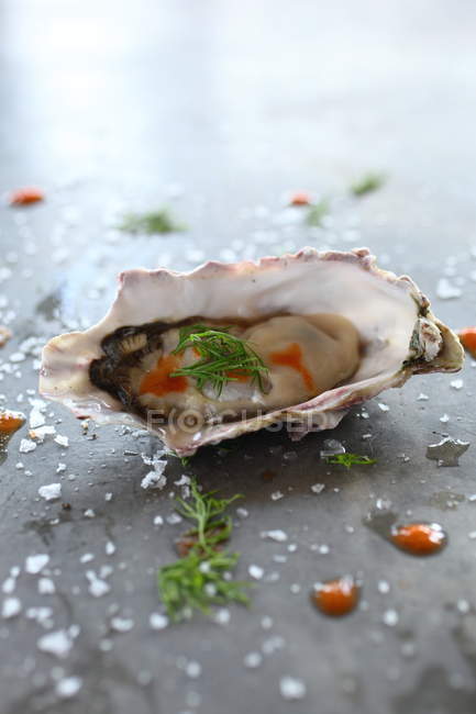 Oyster with tabasco chili sauce and salt — Stock Photo