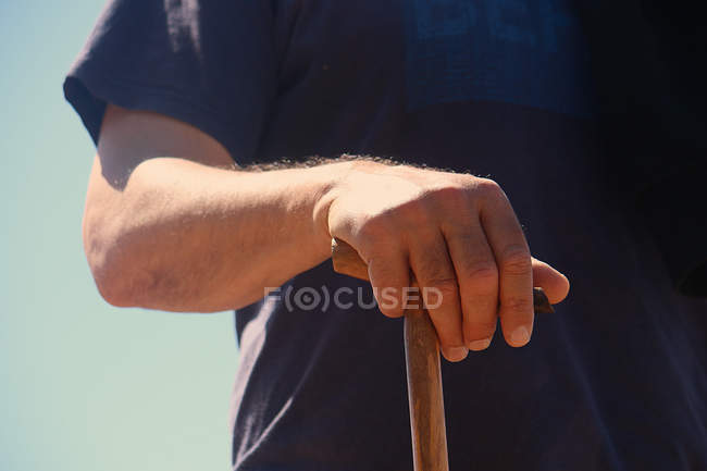 Cropped image of senior man holding a walking stick — Stock Photo