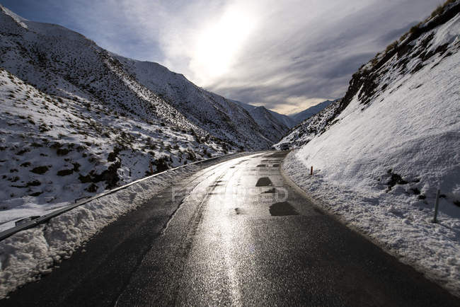 Vista panorâmica da estrada vazia entre cobertos de montanhas de neve, Nova Zelândia — Fotografia de Stock