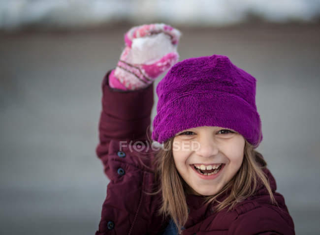Portrait of laughing girl holding snowball — Stock Photo