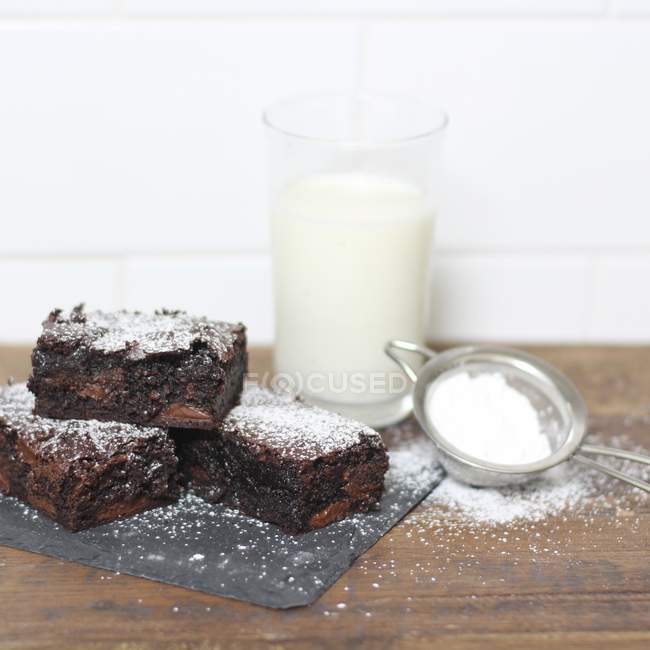 Chocolate brownies dusted with icing sugar — Stock Photo