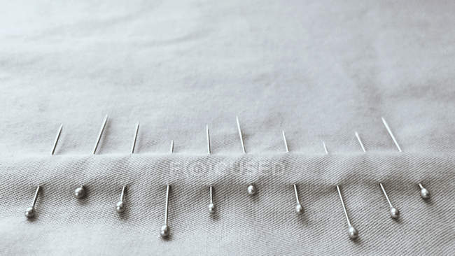 Closeup view of material with stacked pins — Stock Photo