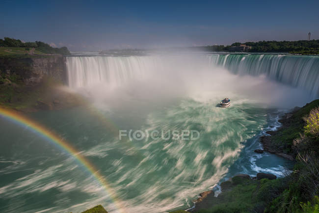 Scenic view of double rainbow over water shot with long exposure, Niagara Falls, Ontario, Canada — Stock Photo