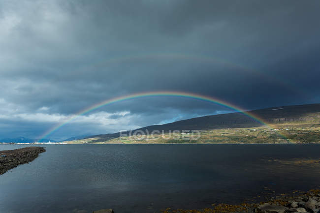 Iceland, Akureyri, double rainbow over Eyjafjordur fjord — Stock Photo