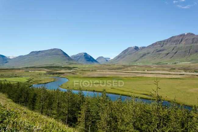 Islandia, Eyjafjordur, Paisaje con montañas, ríos y pinos - foto de stock